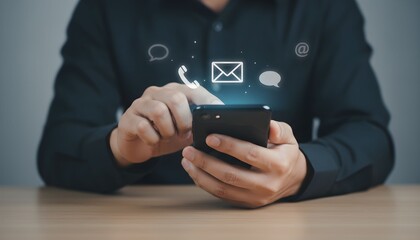 Person using a smartphone with communication icons representing digital connection and online messaging for business and personal use