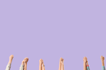 Many women holding hands on lilac background. Feminism concept