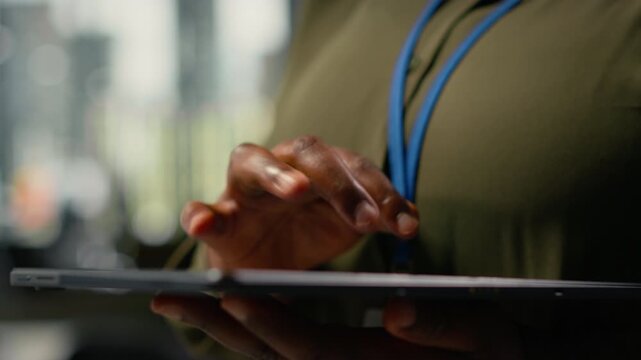 Close up of tablet used by programmer in office to accelerate complex artificial intelligence calculations. IT employee using touchscreen device to train deep learning datasets systems, camera B