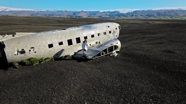 Aerial drone footage of DC-3 wreck, Solheimasandur, Iceland. Cinematic 4K ProRes captures abandoned aircraft fuselage on vast black sand desert plain.
