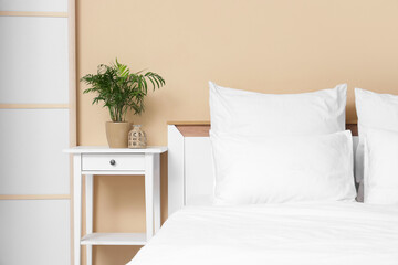 Interior of room with white linen on bed and table