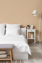 Interior of room with white linen on bed and table