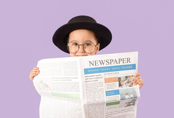 Fototapeta premium Cute little detective with newspaper on lilac background