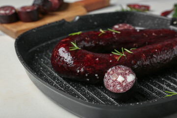 Grill pan with tasty blood sausage on white background, closeup