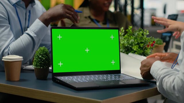 Green screen laptop used by programmers in startup office leveraging AI tech to gain competitive edge. Management doing meeting to discuss training deep learning models using mockup notebook, camera B