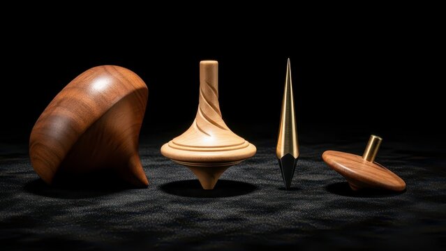 Collection of Four Wooden Spinning Tops on a Dark Surface.