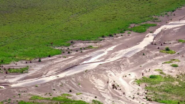 Segara Wedi. Gorgeous flatland texture situated near active volcano Mount Bromo. Stretch of land crossed by sandy areas. Indonesian landscape. Aerial view, long shot. East Java, Indonesia. Panoramic