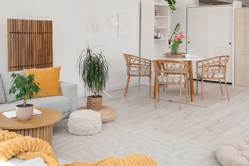 Interior of modern studio apartment with sofa and dining table