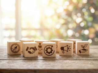 Leadership overview icons on wooden cubes placed using shallow focus and bright softly blurred surroundings