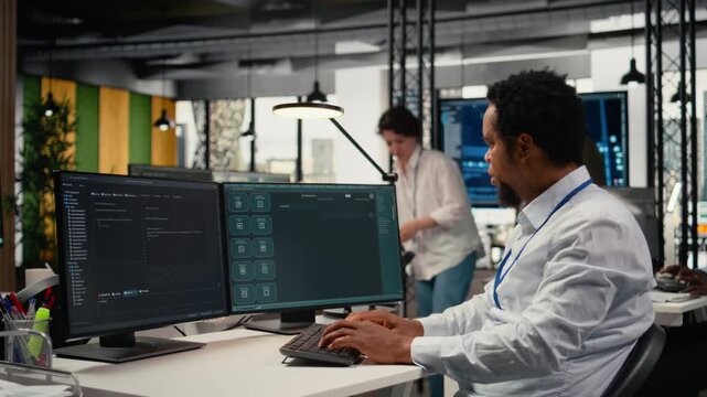 Programmer in office using AI LLM chatbot to get help optimizing systems performance metrics. IT worker in tech agency utilizing generative AI LLM assistant for faster software development, camera A