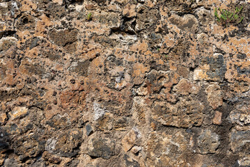 Background with a worn rustic stone texture in natural colors and a rough surface.