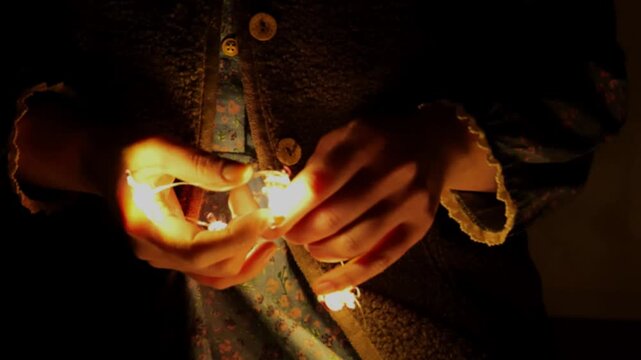 Christmas garlands.Preparations for Christmas and New Year.Hands untangle garlands in the dark. 4k footage