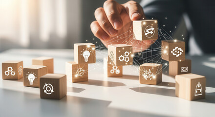 Open innovation network and linking various scattered cubes together using wooden cubes, symbolic icons, human hand, natural depth of field, soft blurred background, clean white desk