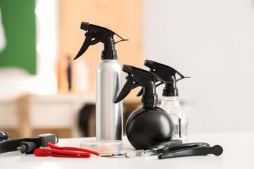Hair sprays with extension tools on table in beauty salon, closeup