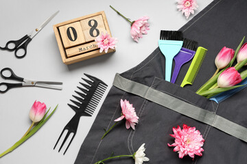 Composition with hairdresser's supplies, spring flowers and calendar with date of International Women's Day on grey background, closeup