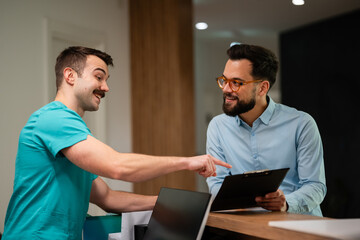 Healthcare receptionist assisting client with check-in process