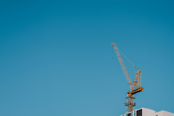 Construction Crane Against Clear Blue Sky &ndash; Minimal Urban Development Concept