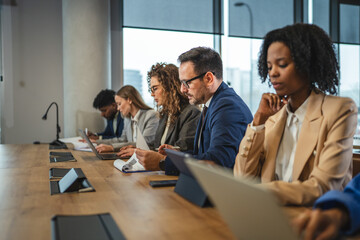 Diverse business professionals attending corporate meeting in modern office