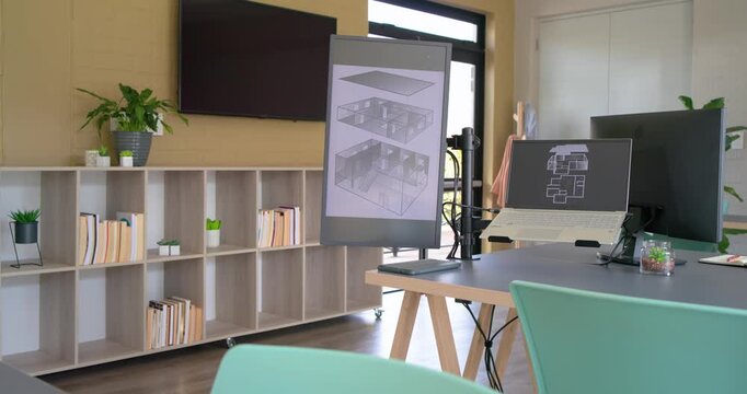 On start, camera pushing forward and panning right showcasing laptop blueprint and rolled plans