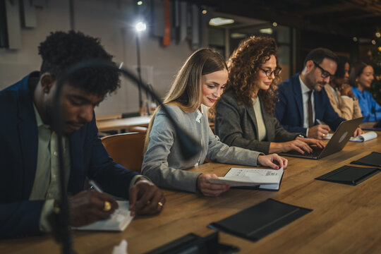 Diverse business professionals collaborating during late evening office meeting - Powered by Adobe