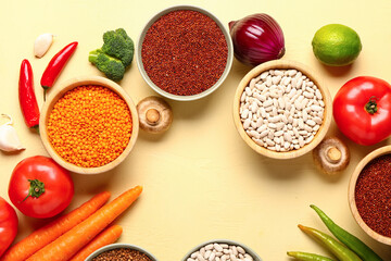 Frame made of different fresh vegetables and cereals on yellow background