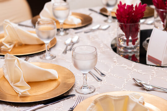 Photograph of an elegantly decorated table for a special event, focusing on the glass of cold water.