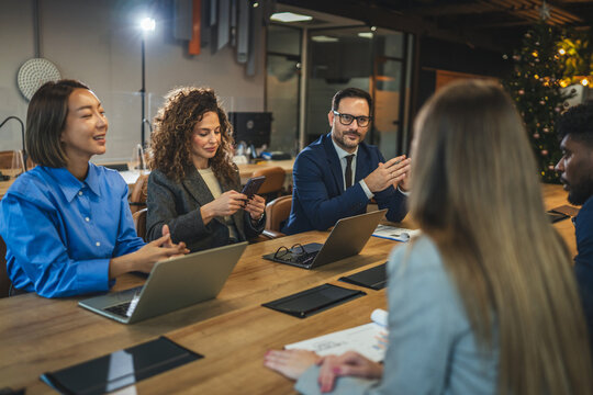 Diverse business team collaborating during a meeting in modern office - Powered by Adobe