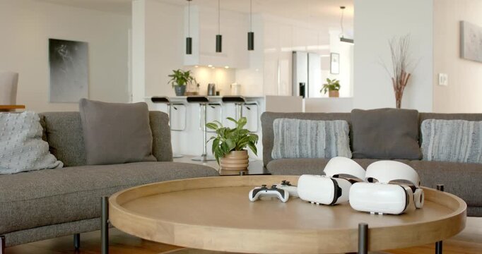 coffee table is featuring two VR headsets and game controller while sitting in home for gaming