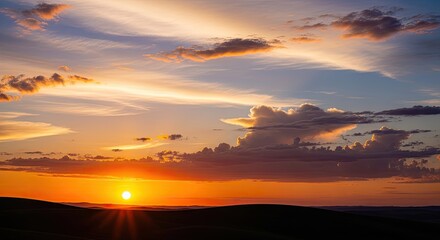 Vibrant Sunset over Rolling Hills with Dramatic Clouds and Golden Light Rays