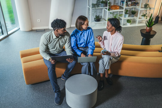 Diverse business team collaborating during informal office meeting