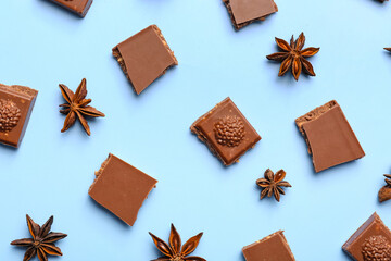 Composition with pieces of tasty chocolate and anise stars on color background