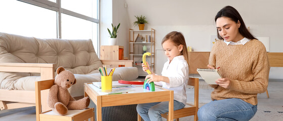 Little girl playing with toy at psychologist's office