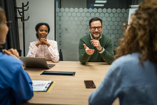 Diverse business professionals having a corporate meeting in modern office - Powered by Adobe