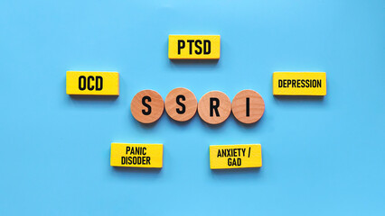 Wooden Blocks Showing SSRI as Treatment Center for PTSD, OCD, Depression, Panic Disorder, and Anxiety Mental Health Acronyms