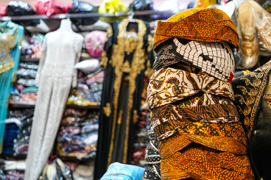 Blangkon, traditional Javanese men's head covering made of batik cloth; Indonesian clothing store traditional market clothes display