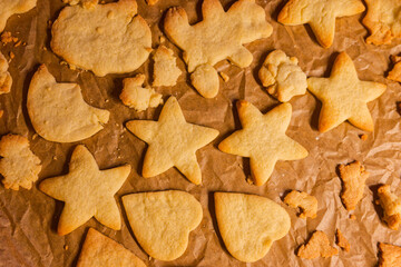 Fresh baked butter cookies in star and heart shapes on warm tray