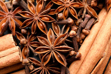 Mulled wine spices. Anise stars, cloves and cinnamon sticks as background, top view