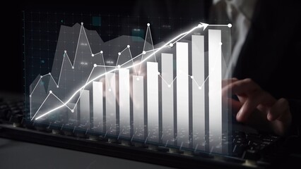 A business professional analyzes financial data on a digital screen, showcasing growth through dynamic graphs and charts in a modern office environment. Copula