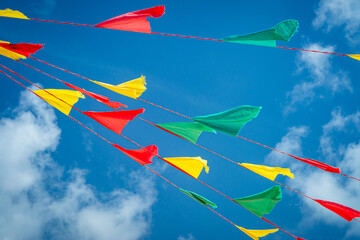 colorful red, yellow and green bunting flags flying in the sky to celebrate Grenada's 50th Anniversary of Independence