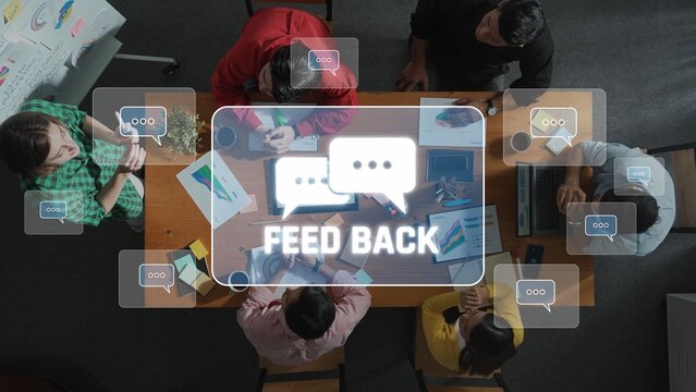 Engaging office meeting scene featuring a diverse team collaborating and discussing project ideas with visual feedback concepts displayed above the table. Raster - Powered by Adobe