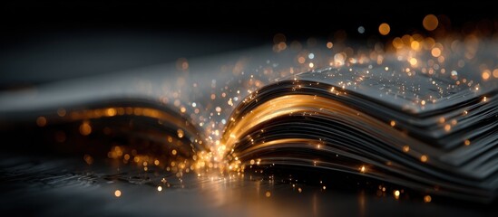 Open book glowing with golden light and sparking particles against a dark background