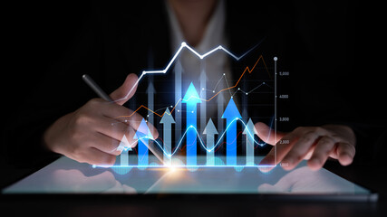 A business professional analyzes financial growth trends with technology graphics displayed on a digital tablet. The scene emphasizes innovation and strategy. Scalp