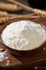 wheat flour and wheat ears on wooden table