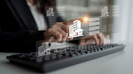A woman interacts with a keyboard while engaging with digital representations of real estate...