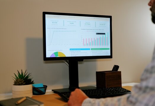 Middle Aged Business Analyst Reviews Clean Energy Conversion Executive Report from Home Office - Green Power Long Term Savings Concept