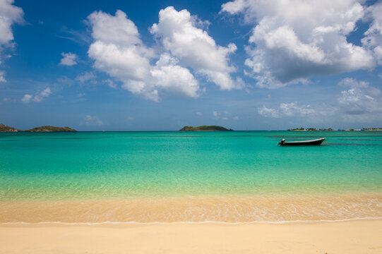 View across the tranquil turquoise lagoon at Carriacou's Paradise Beach to Mabouya Island and Sandy Island on the horizon.