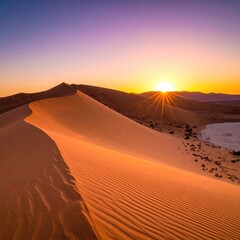 Desert dune with sunburst at horizon
