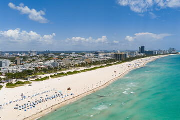Miami beach with turquoise waters. Aerial view of sandy coastline and waves.