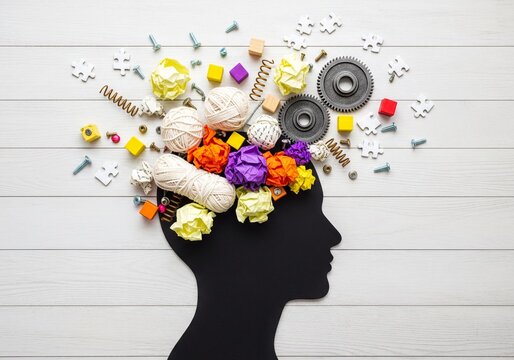 Black human head silhouette filled with colorful objects symbolizing thoughts ideas and creativity