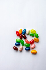 Close up top view texture background of colorful jellybeans randomly grouped on a white background